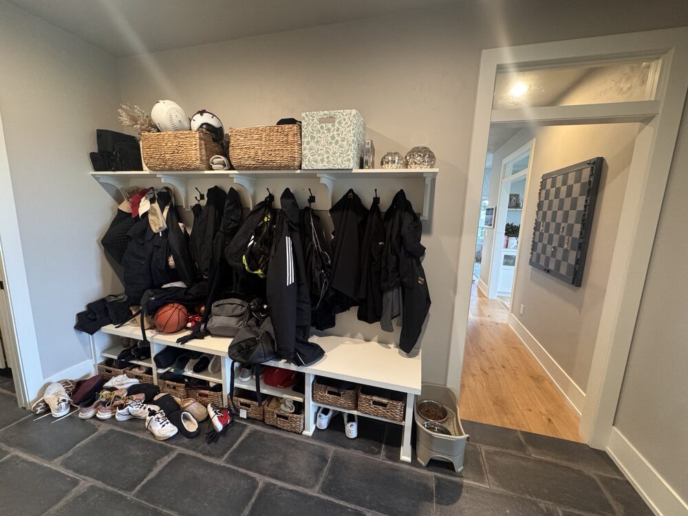 Before: cluttered mudroom bench with mismatched items