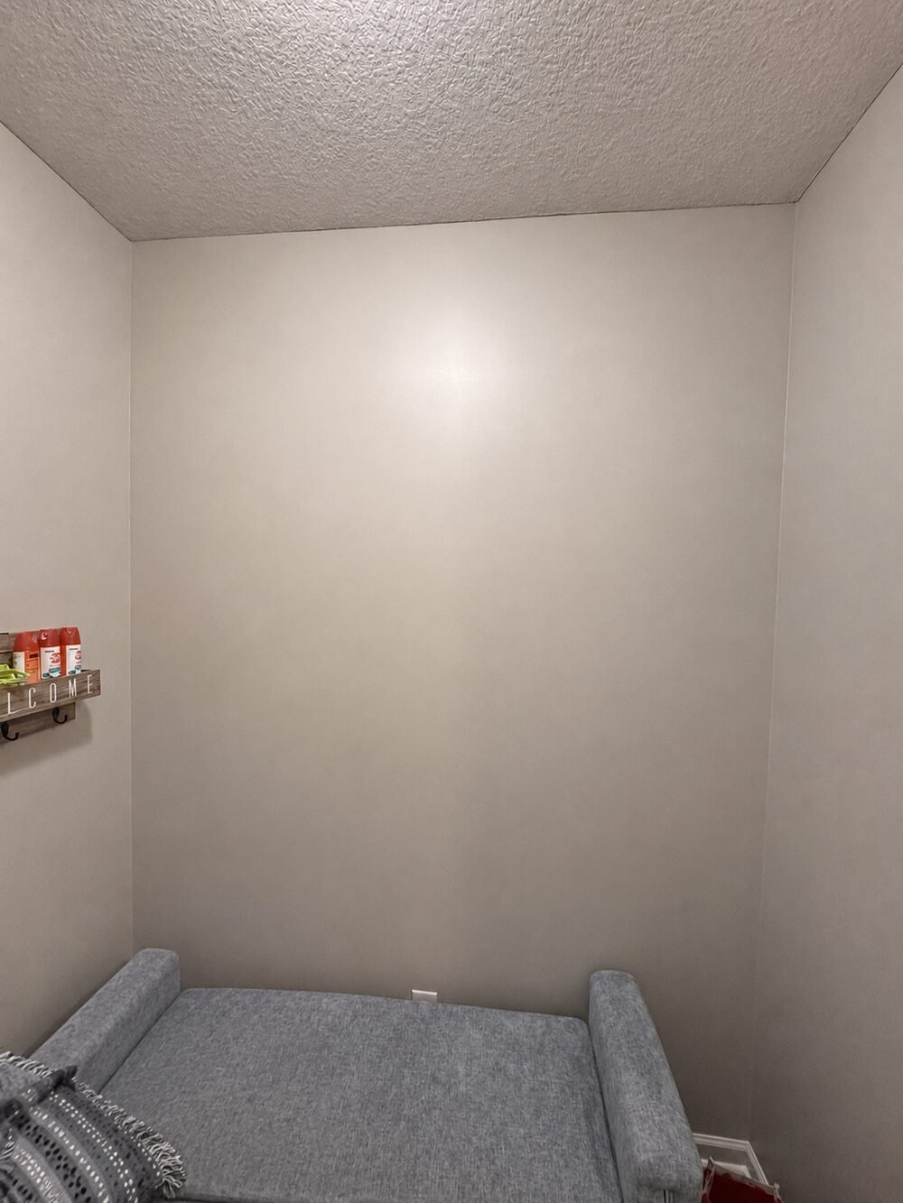Before: blank mudroom wall with just a bench